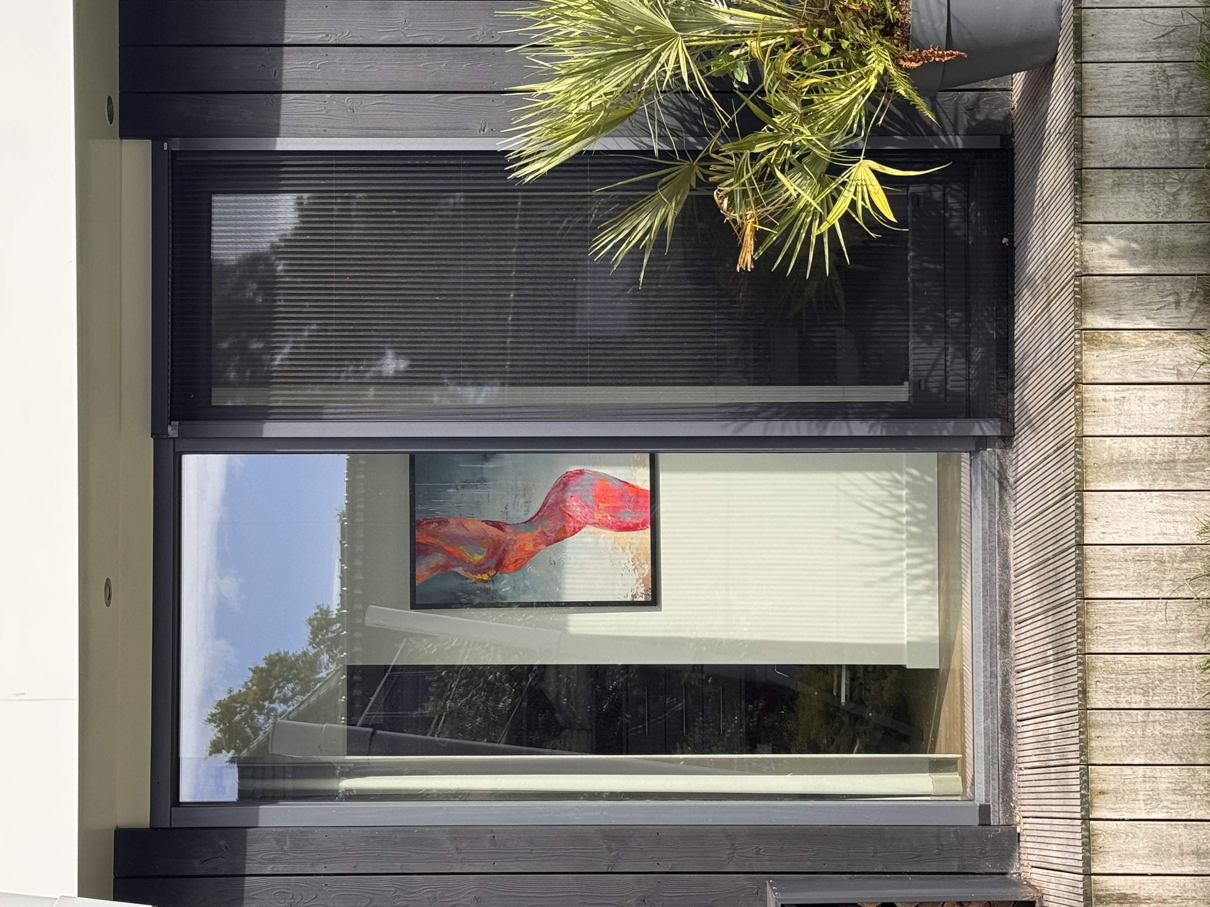 Sonia Anton painting in a modern home exterior view